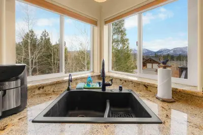 a kitchen with a sink and two windows at Lookout Point - Retreat for 6 in South Lake Tahoe