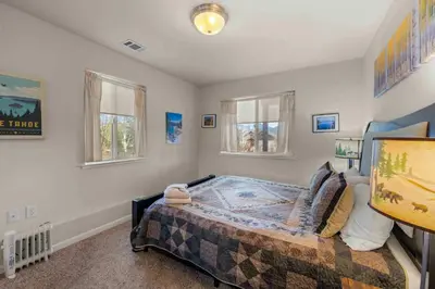 a bedroom with a bed and two windows at Lookout Point - Retreat for 6 in South Lake Tahoe