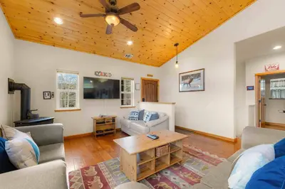 a living room with a couch and a table at Lookout Point - Retreat for 6 in South Lake Tahoe