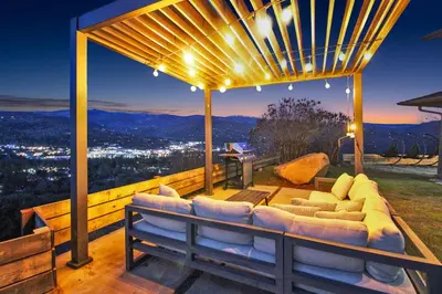 a patio with a couch and a view of the city at Yosemite Retreat, Views and Hot Tub in Oakhurst