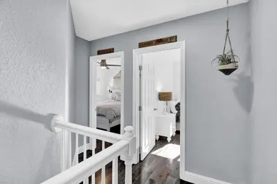 a room with a staircase and a bedroom with a bed at Yosemite Retreat, Views and Hot Tub in Oakhurst