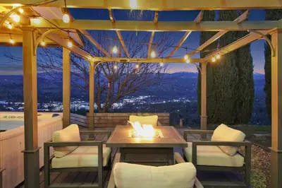 a patio with a table and chairs with a view at Yosemite Retreat, Views and Hot Tub in Oakhurst