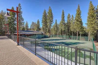 a tennis court with a net on top of it at Newly Remodeled 2Bd 2Ba Condo in NorthStar in Truckee