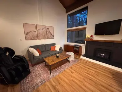 a living room with a couch and a fireplace at Newly Remodeled 2Bd 2Ba Condo in NorthStar in Truckee