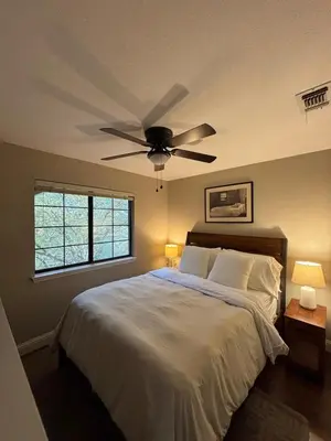 a bedroom with a bed with a ceiling fan at Canyon Ridge Retreat in Folsom