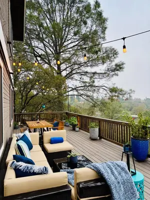 a patio with couches and tables on a deck at Canyon Ridge Retreat in Folsom