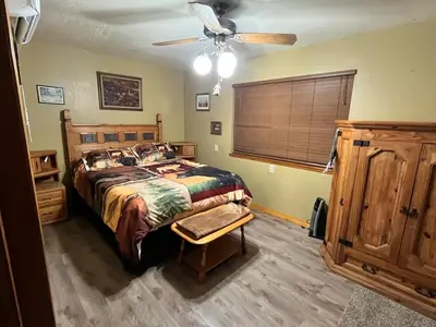 a bedroom with a bed and a ceiling fan at Twain Harte Cozy cabin downtown in Twain Harte