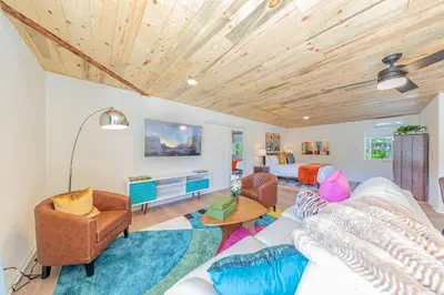 a living room with a couch and a bed at Skyfalls Retreat Mid-Century Guesthouse near Yosemite in Oakhurst