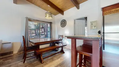 a dining room with a table and a refrigerator at Chateau Doex #8 condo in Mammoth Lakes