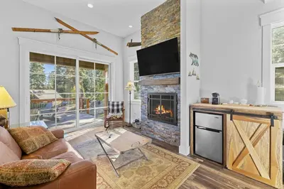 a living room with a couch and a fireplace at Lakeview Luxury Retreat with Hot Tub and Game Room in Carnelian Bay