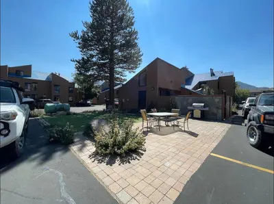 a patio with a table and chairs in a parking lot at Forest Meadows 8 in Mammoth Lakes