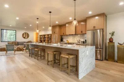an open kitchen with a large island with bar stools at Obsidian 104 in Mammoth Lakes