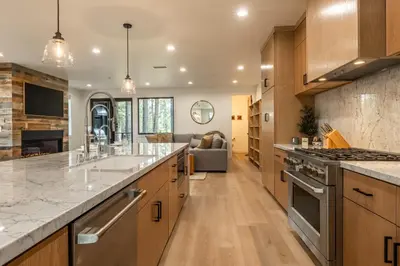 a kitchen with wooden cabinets and a large counter top at Obsidian 104 in Mammoth Lakes