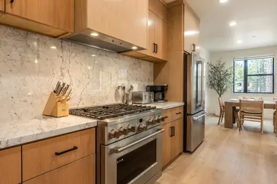a kitchen with a stove and a dining room at Obsidian 104 in Mammoth Lakes