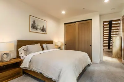 a bedroom with a large bed and a wooden door at Obsidian 104 in Mammoth Lakes