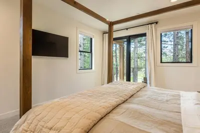 a bedroom with a large bed with a flat screen tv at Obsidian 104 in Mammoth Lakes