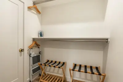 two wooden chairs in a closet with a door at Obsidian 104 in Mammoth Lakes