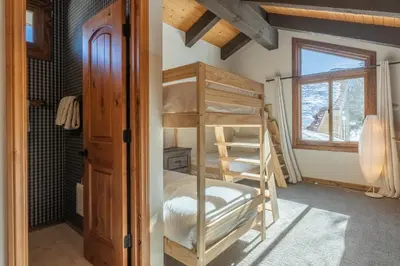 a bunk bed in a room with a window at Mammoth Creek 36 in Mammoth Lakes