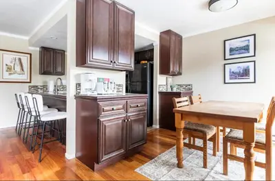 a kitchen with wooden cabinets and a table and chairs at Discovery Four 109 in Mammoth Lakes