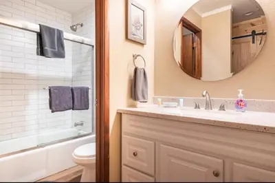 a bathroom with a sink and a toilet and a mirror at Discovery Four 109 in Mammoth Lakes