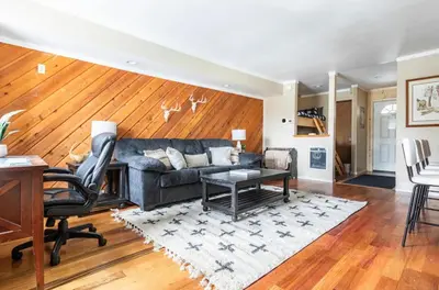a living room with a couch and a table at Discovery Four 109 in Mammoth Lakes