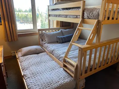 a bunk bed and a couch in a room at Juniper Springs Lodge 437 in Mammoth Lakes