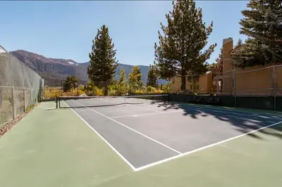 a tennis court with a tennis racket on it at Mammoth Creek 29 in Mammoth Lakes