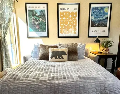 a bedroom with a bed and some pictures on the wall at Mammoth Estates 138 in Mammoth Lakes