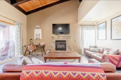 a living room with a couch and a fireplace at Mammoth Estates 138 in Mammoth Lakes
