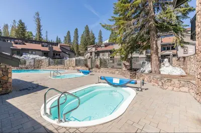 a swimming pool with a hot tub in a yard at Chamonix 17 in Mammoth Lakes