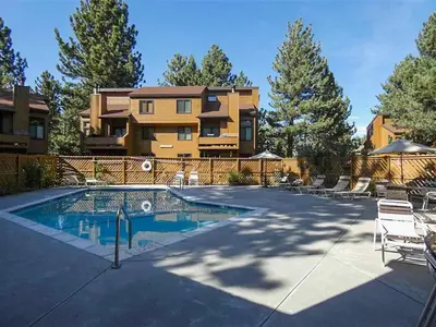 a swimming pool in front of a house at Wildflower 65 in Mammoth Lakes