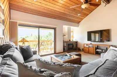 a living room with a couch and a tv at Snowcreek 290 in Mammoth Lakes