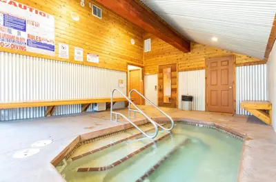 a swimming pool in a building with a wooden ceiling at San Sierra 19 in Mammoth Lakes