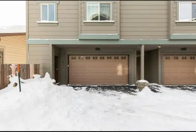 a house with two garage doors in the snow at Gray Eagle 5 in Mammoth Lakes