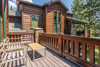 a deck with two chairs and a cabin at Stonegate 11 in Mammoth Lakes