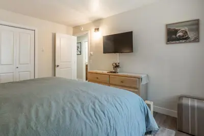 a bedroom with a bed and a flat screen tv at Chateau De Montagne 4 in Mammoth Lakes