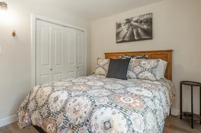 a bedroom with a bed with a comforter and pillows at Chateau De Montagne 4 in Mammoth Lakes