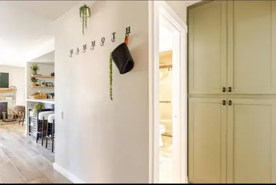a living room with a white wall and a door at Seasons Four 165 in Mammoth Lakes