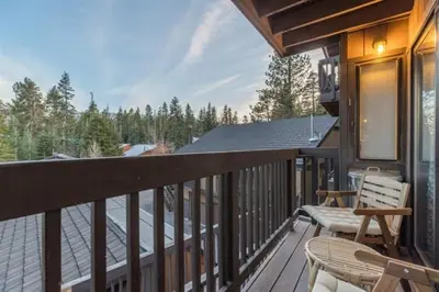 a balcony with a table and chairs on a house at Bigwood 5 in Mammoth Lakes