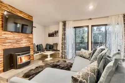 a living room with a couch and a fireplace at Bigwood 5 in Mammoth Lakes