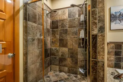 a bathroom with a shower with a glass door at Timbers 1031 in Mammoth Lakes