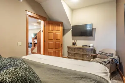 a bedroom with a bed and a flat screen tv at Timbers 1031 in Mammoth Lakes