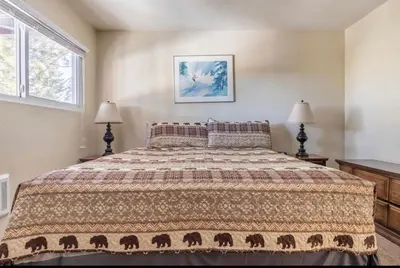 a bedroom with a large bed and two lamps at Mammoth View Villas 20 in Mammoth Lakes