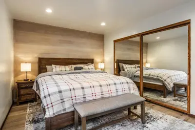 a bedroom with two beds and a mirror at Canyon Ski and Racquet 3 in Mammoth Lakes