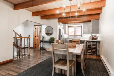 a dining room and kitchen with a table and chairs at Winterset 20 in Mammoth Lakes
