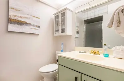 a bathroom with a sink and a toilet and a mirror at Seasons Four 193 in Mammoth Lakes