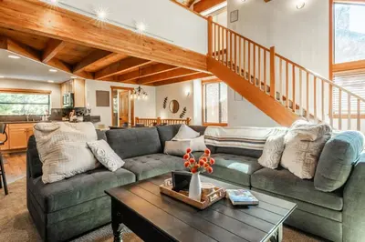 a living room with a couch and a table at Snowflower 21 in Mammoth Lakes