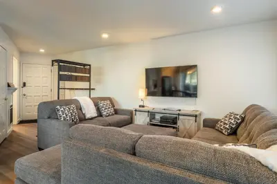 a living room with two couches and a tv at Sierra Park Villas 17 in Mammoth Lakes