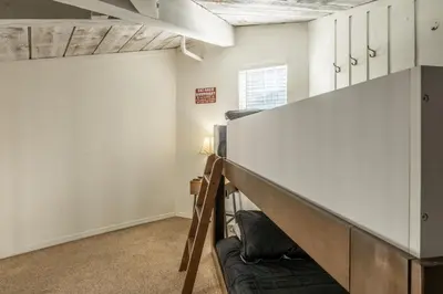 a room with a bunk bed and a couch at Sierra Park Villas 17 in Mammoth Lakes