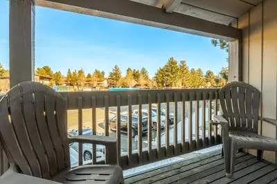two chairs sitting on a porch looking out a window at Sierra Park Villas 17 in Mammoth Lakes
